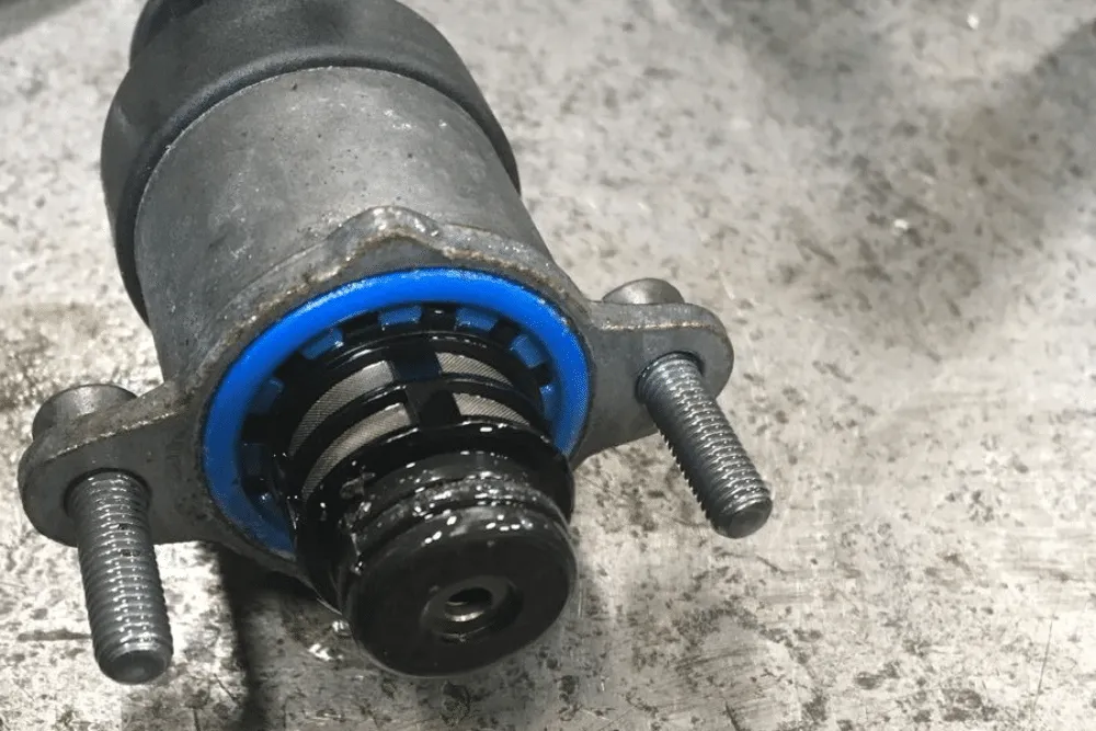 CP4 failure repair in Palmer, AK by 1023 Diesel & Fleet. Image of a Ford 6.7 Powerstroke CP4 fuel pump with visible metal debris and signs of fuel contamination.