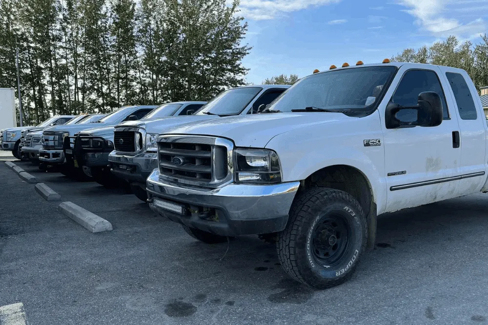Diesel fleet maintenance, diesel repair in Palmer, AK by 1023 Diesel & Fleet. Image of multiple work trucks lined up in a parking lot, showcasing commercial fleet vehicles maintained for reliability, safety, and daily job performance.