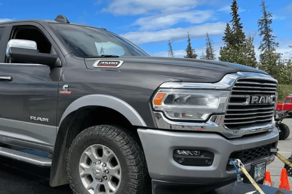 Eagle River Diesel Truck Repair, diesel repair in Palmer, AK at 1023 Diesel & Fleet. Gray RAM 3500 heavy-duty truck with a Cummins diesel engine, secured with tow straps.